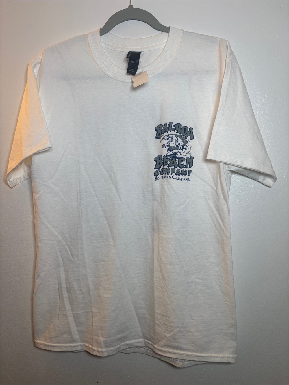 short-sleeve t-shirt with a reading logo "Balboa Beach Company. Size Medium